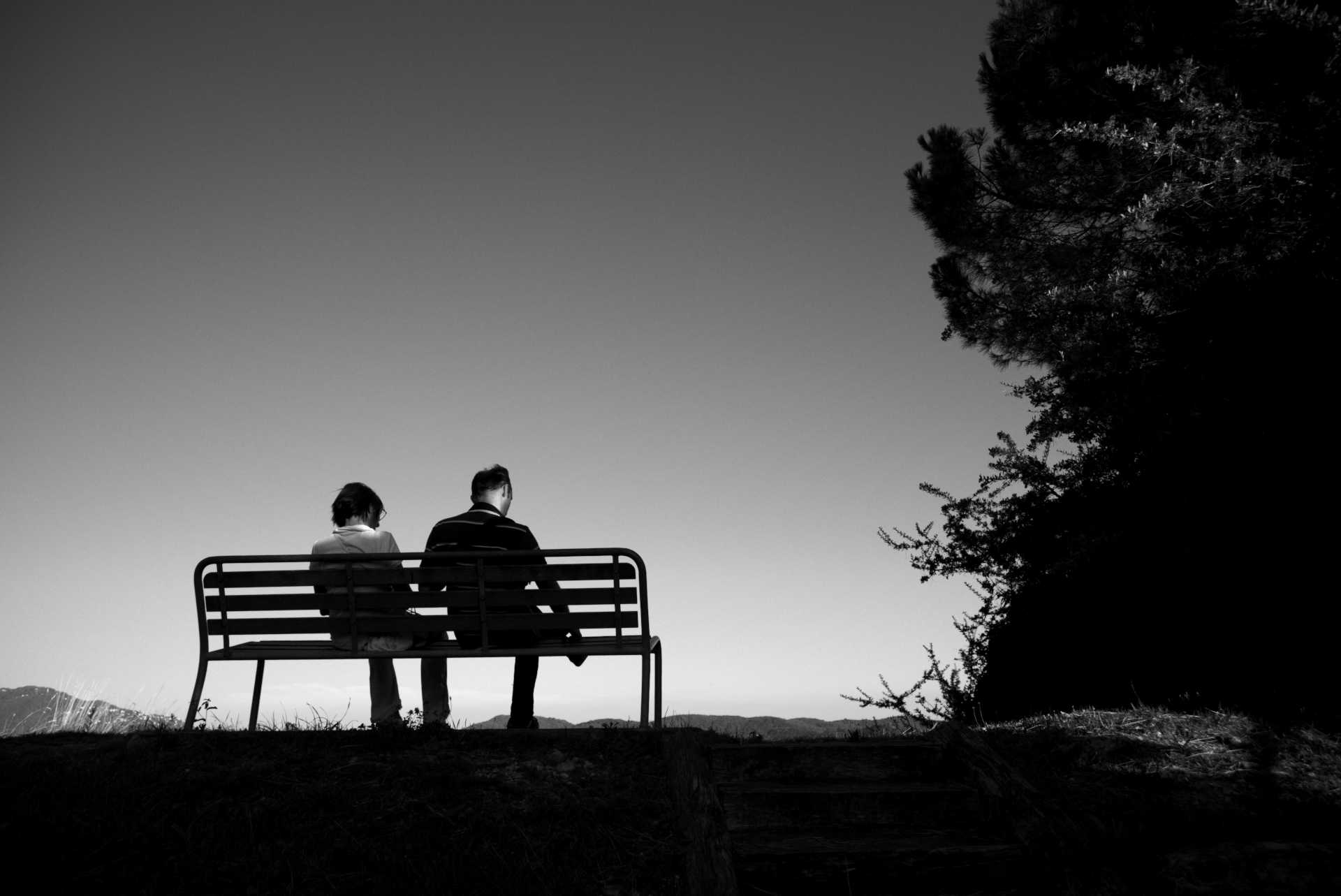 Two people sitting on a bench